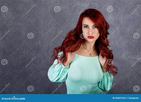 Portrait of beautiful redhead young woman with big boobs in a。